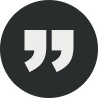 A black circle with two white quotation marks in the center, indicating a quote or quotation icon.